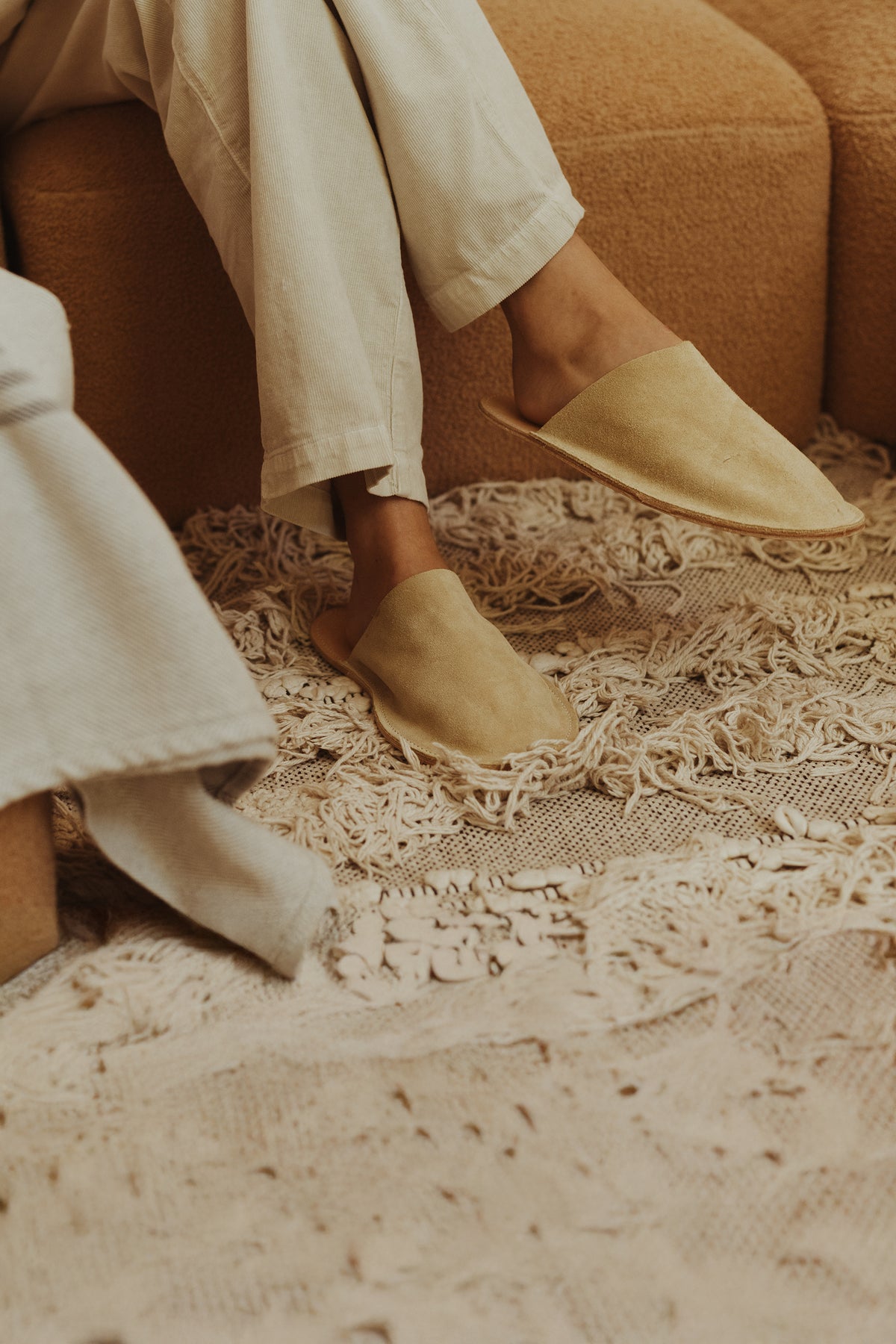 Sand room slippers with open back, moccasin stitching, and cushioned insole