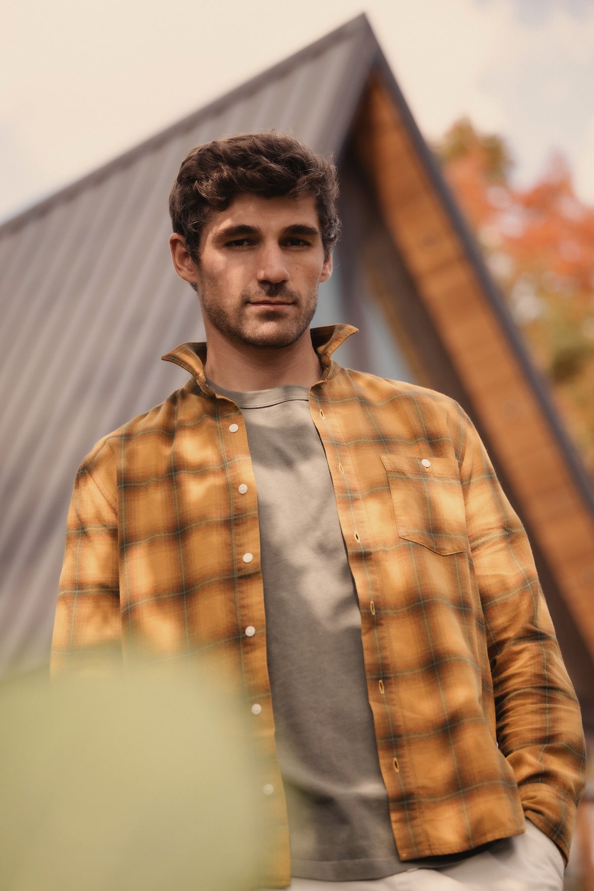 Orange and blue plaid long sleeve flannel shirt with button front and chest pockets