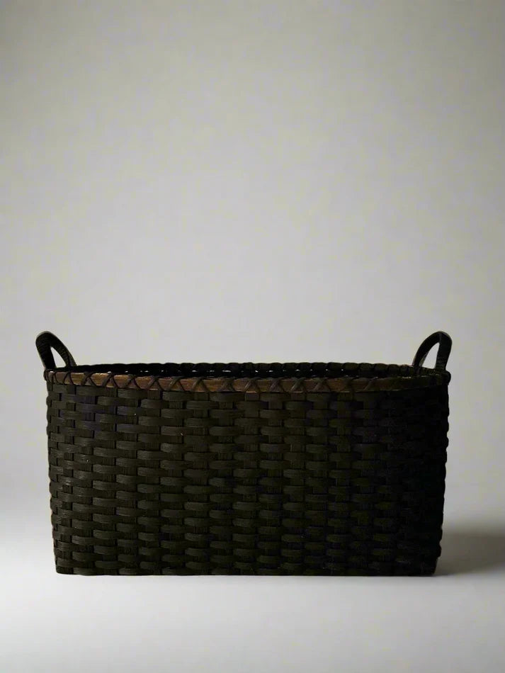 Dark woven basket with two loop handles, rectangular form