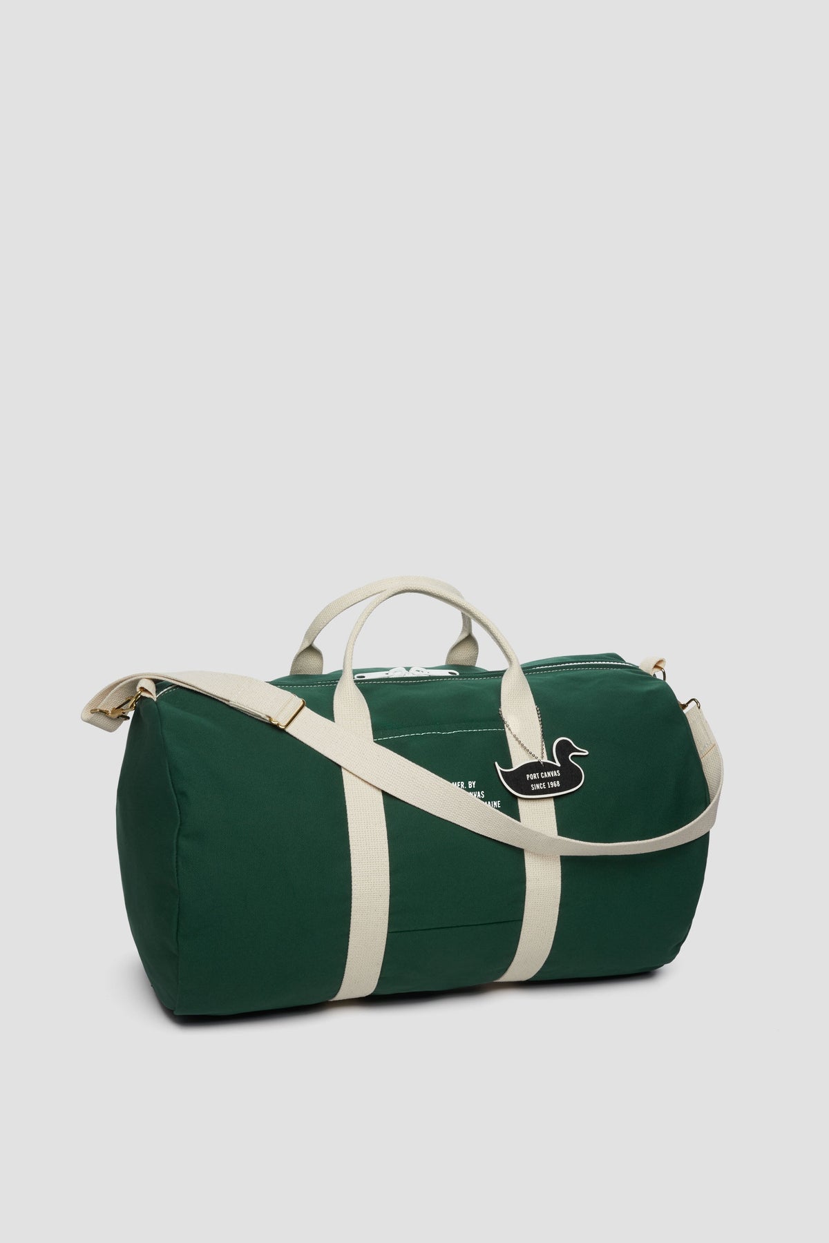 Green duffel bag with cream stripe bands and kangaroo logo patch