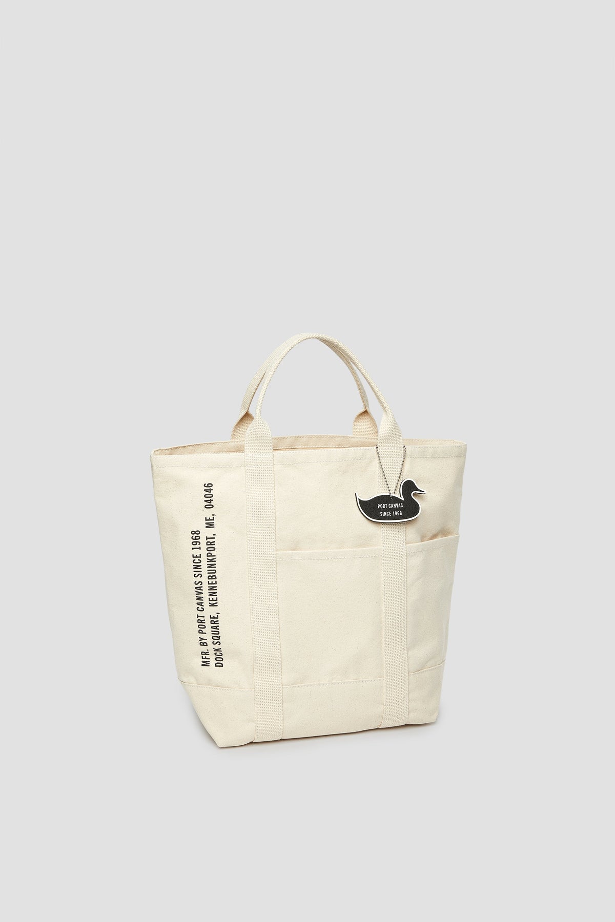 Natural canvas tote with cat patch and vertical white lettering on side