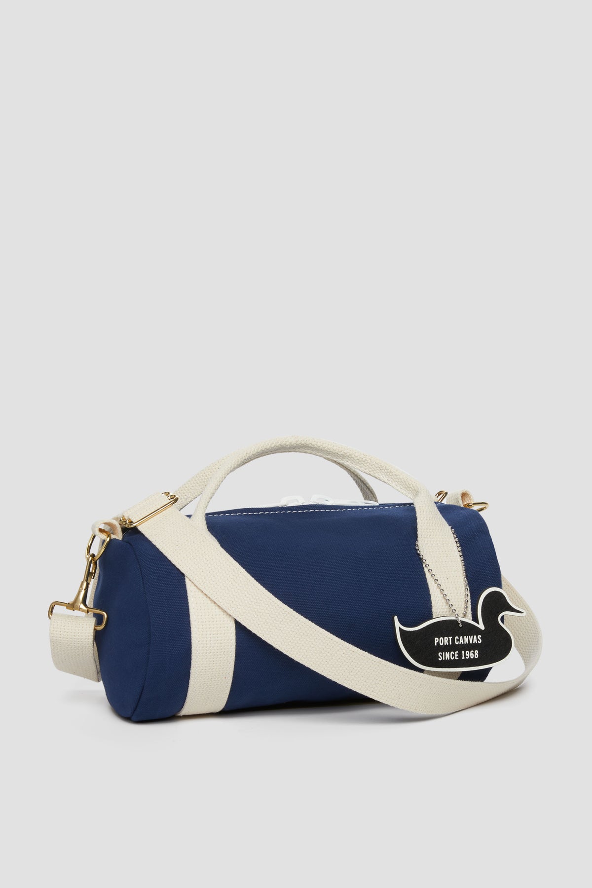 Navy duffel kit bag with white stripe, top handles, zip closure, side logo patch