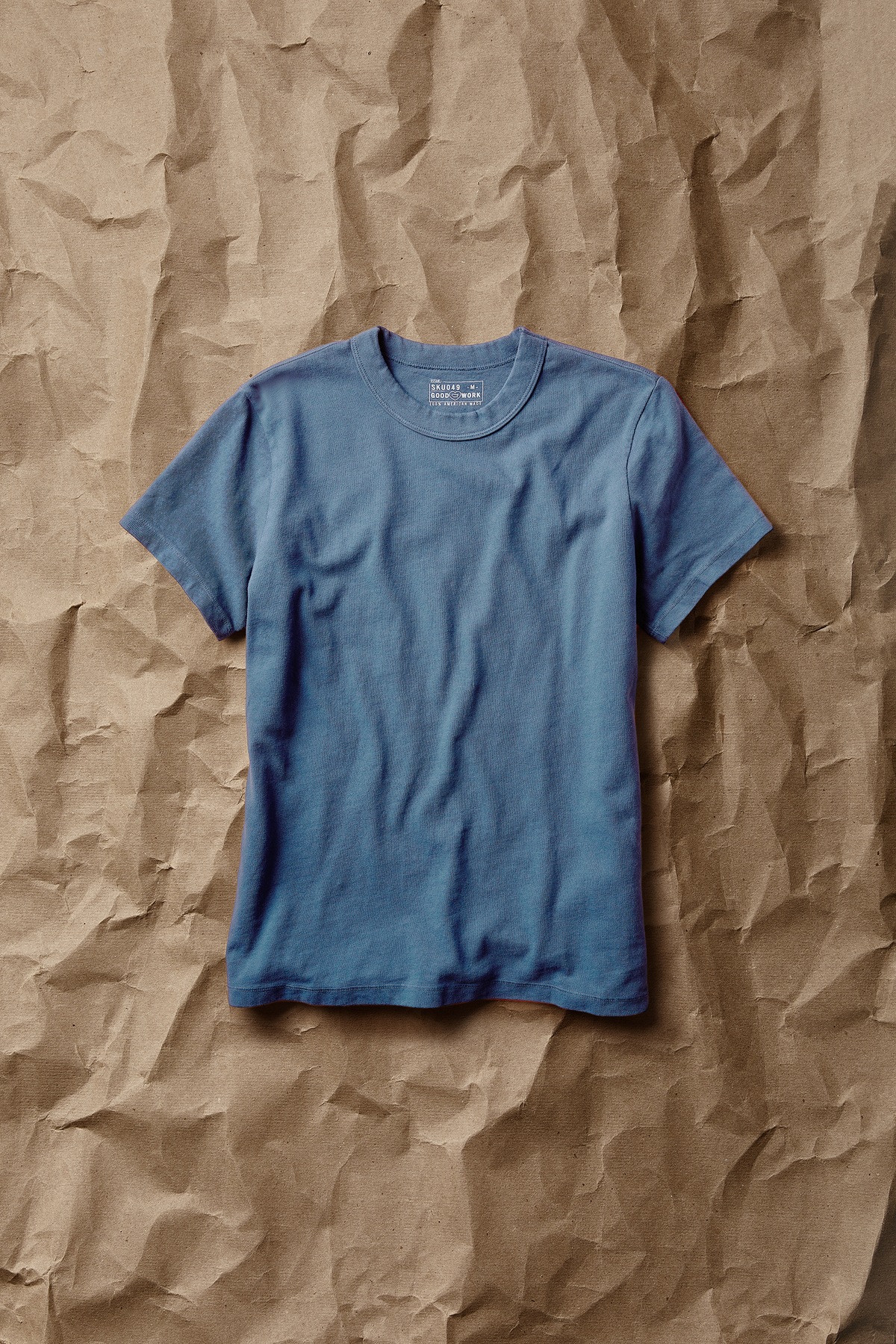 Light blue short-sleeve crew-neck T-shirt with ribbed crew collar and straight hem.