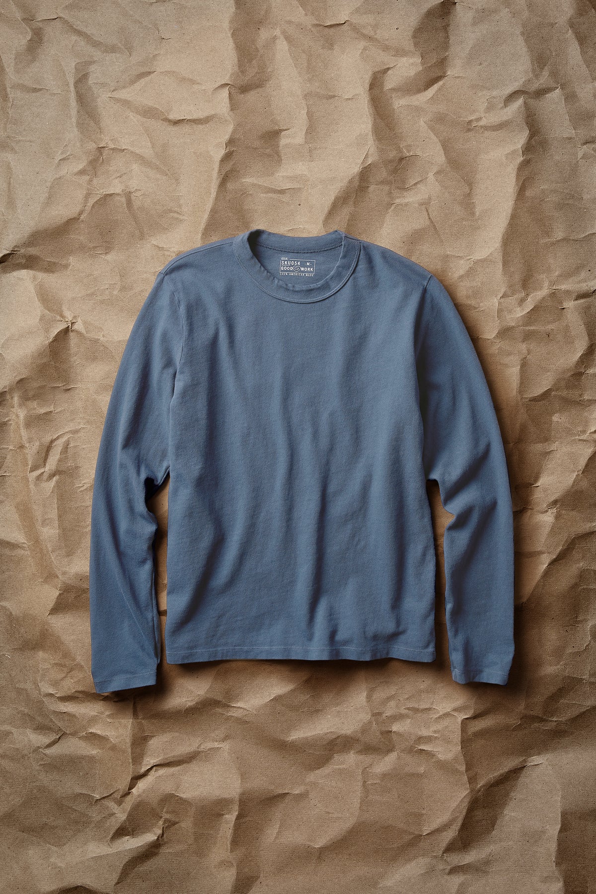 Slate blue long-sleeve layer tee with crew neck and ribbed collar, laid flat front view