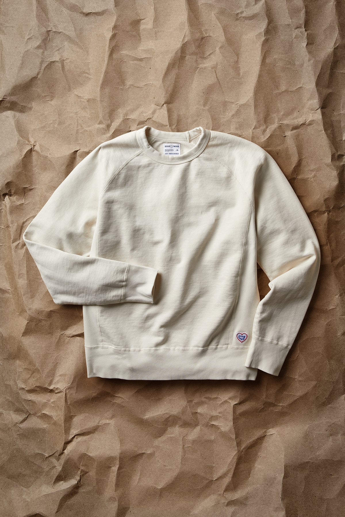 White crew neck terry sweatshirt with long sleeves and small chest logo