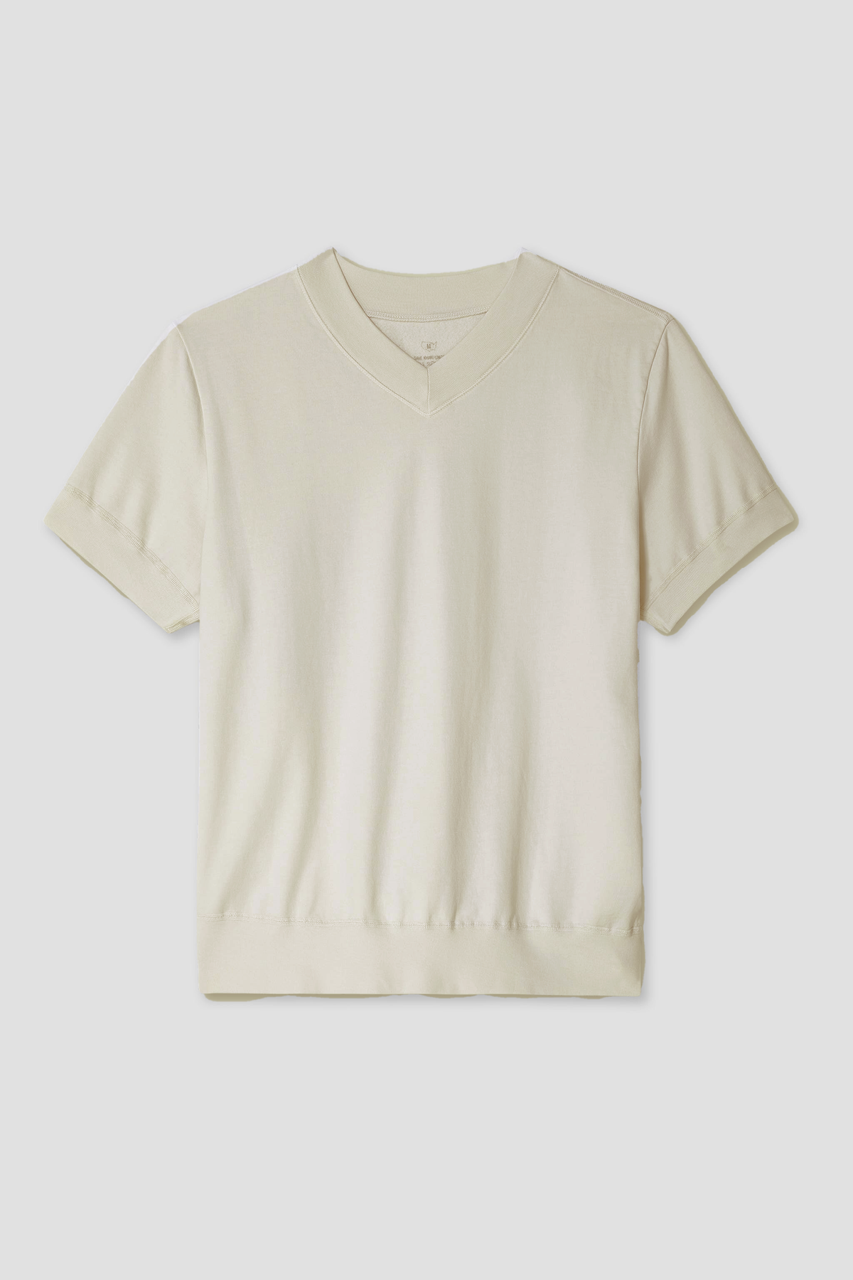 Cream V-neck sweatshirt laid flat, short sleeves, ribbed hem
