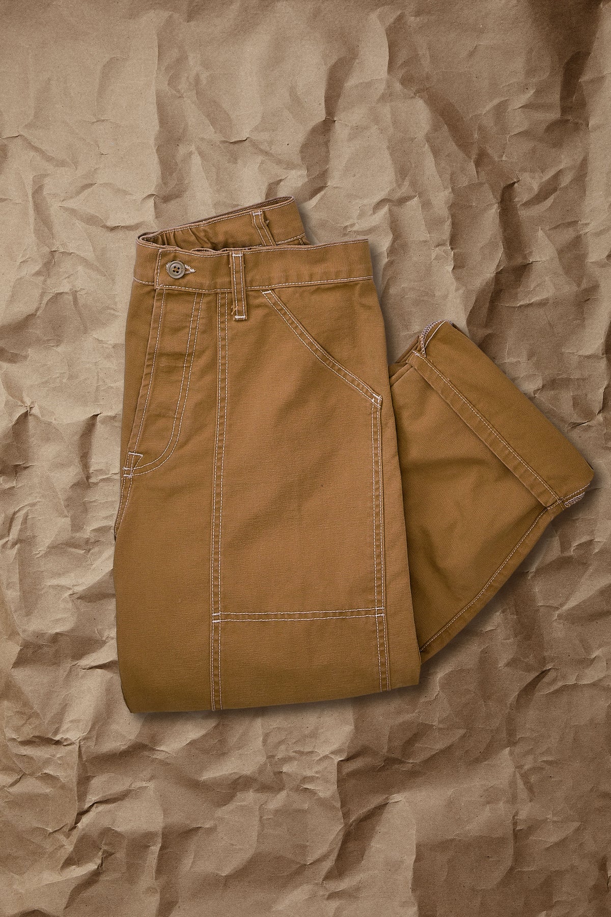 Brown canvas dungarees with front zipper and adjustable shoulder straps