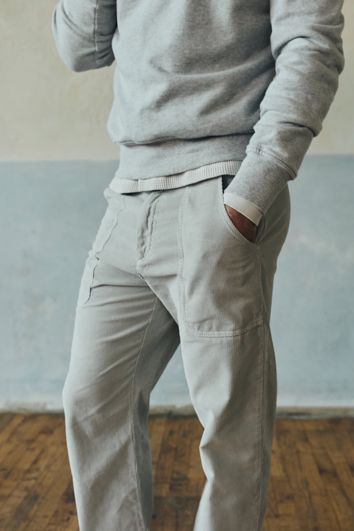 Light gray corduroy pants with elastic waist and side patch pockets, straight legs