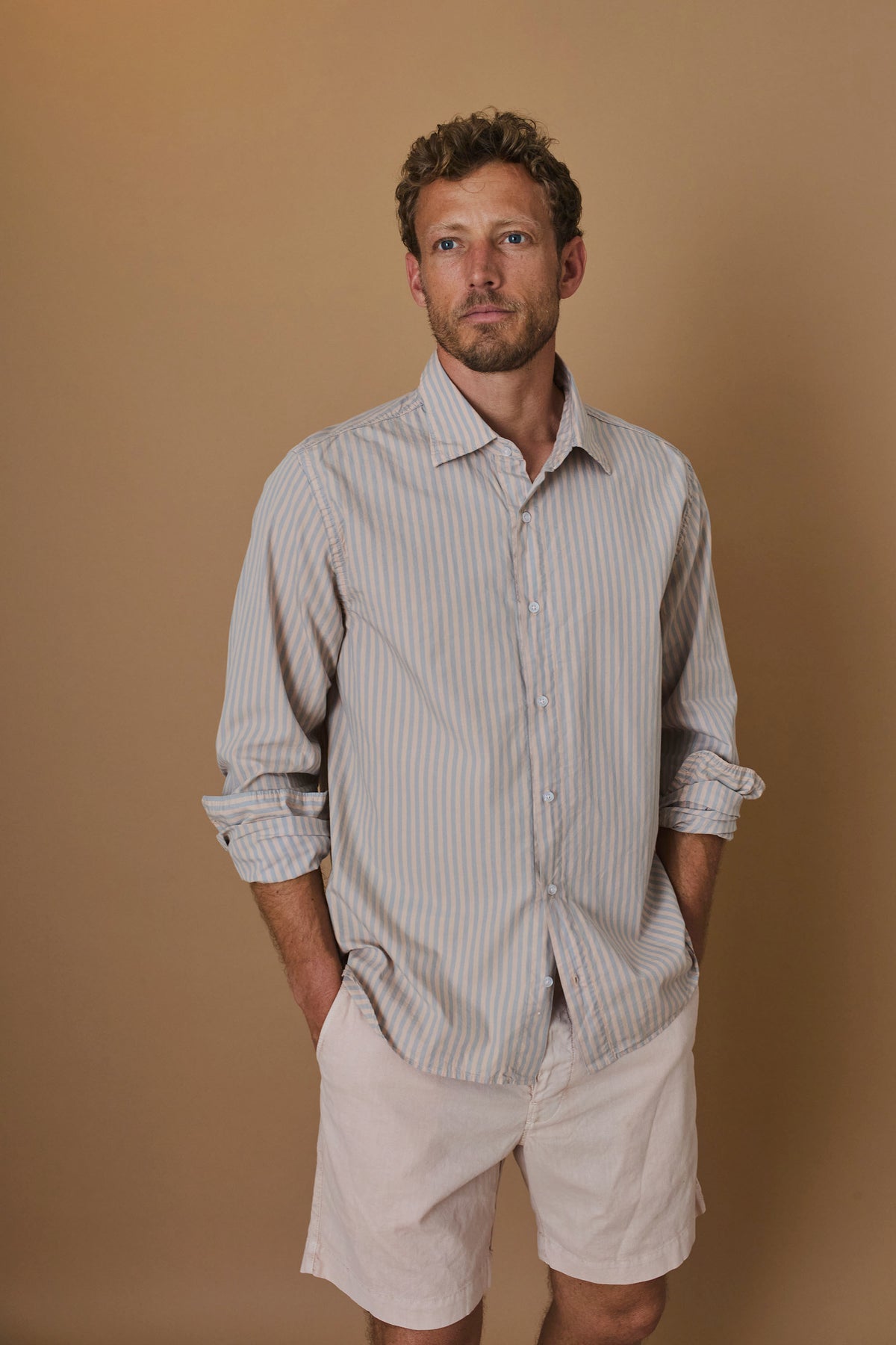 Long-sleeve striped button-up shirt in light blue and white with front buttons
