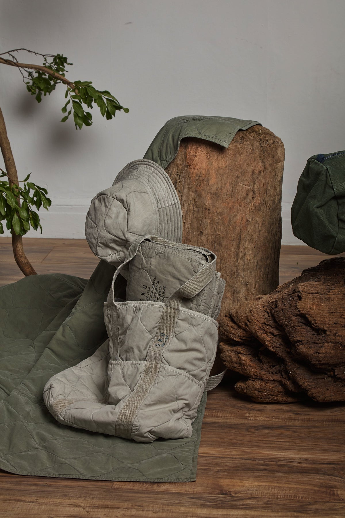 Utility quilted throw in olive green, folded with quilted stitching