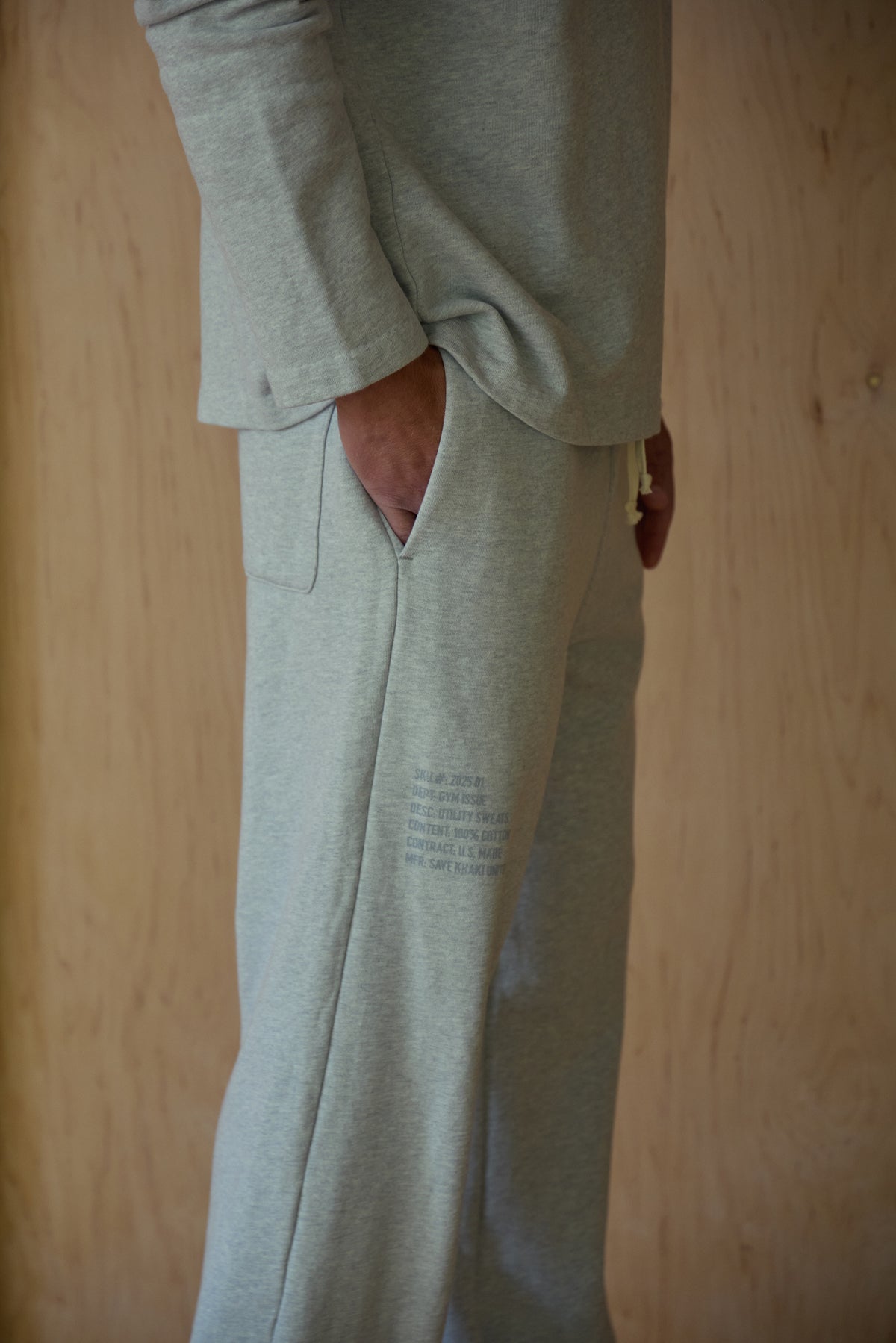 Light heather grey sweatpants with back seam detail and side pocket opening
