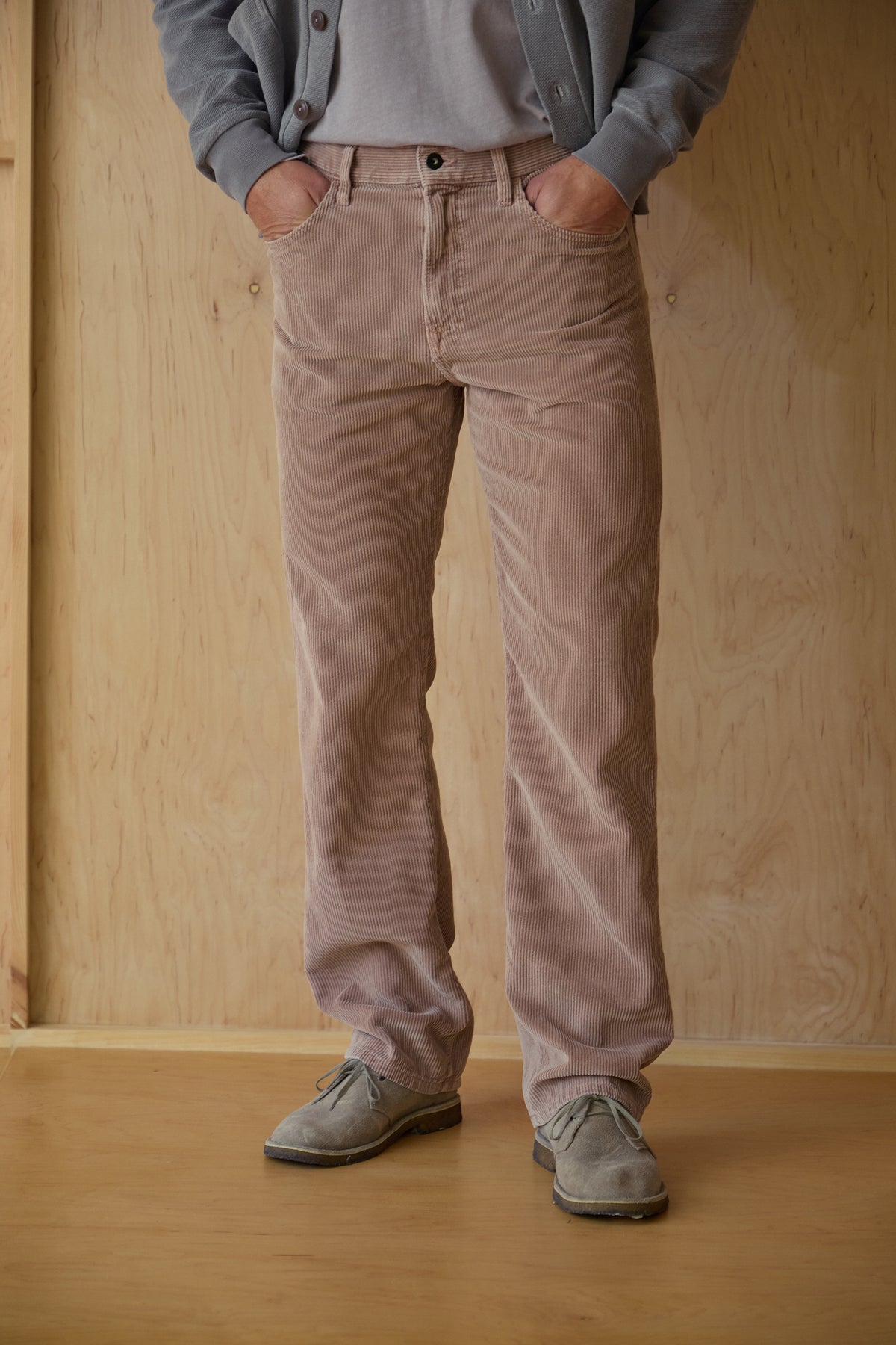 Light tan 5-pocket cord jeans on model, front view with button fly.
