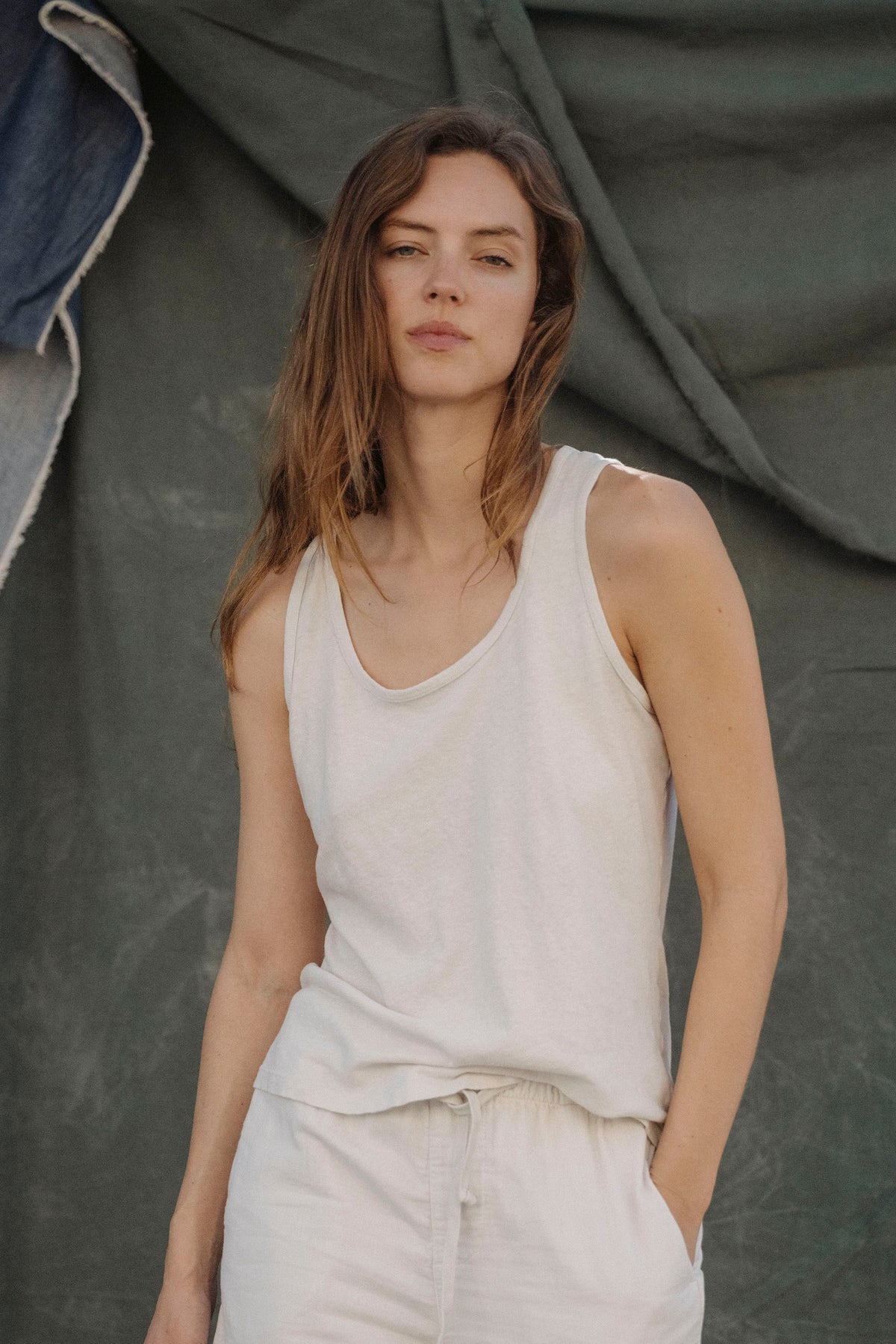 White scoop-neck cotton-hemp tank top on model, sleeveless with wide straps.