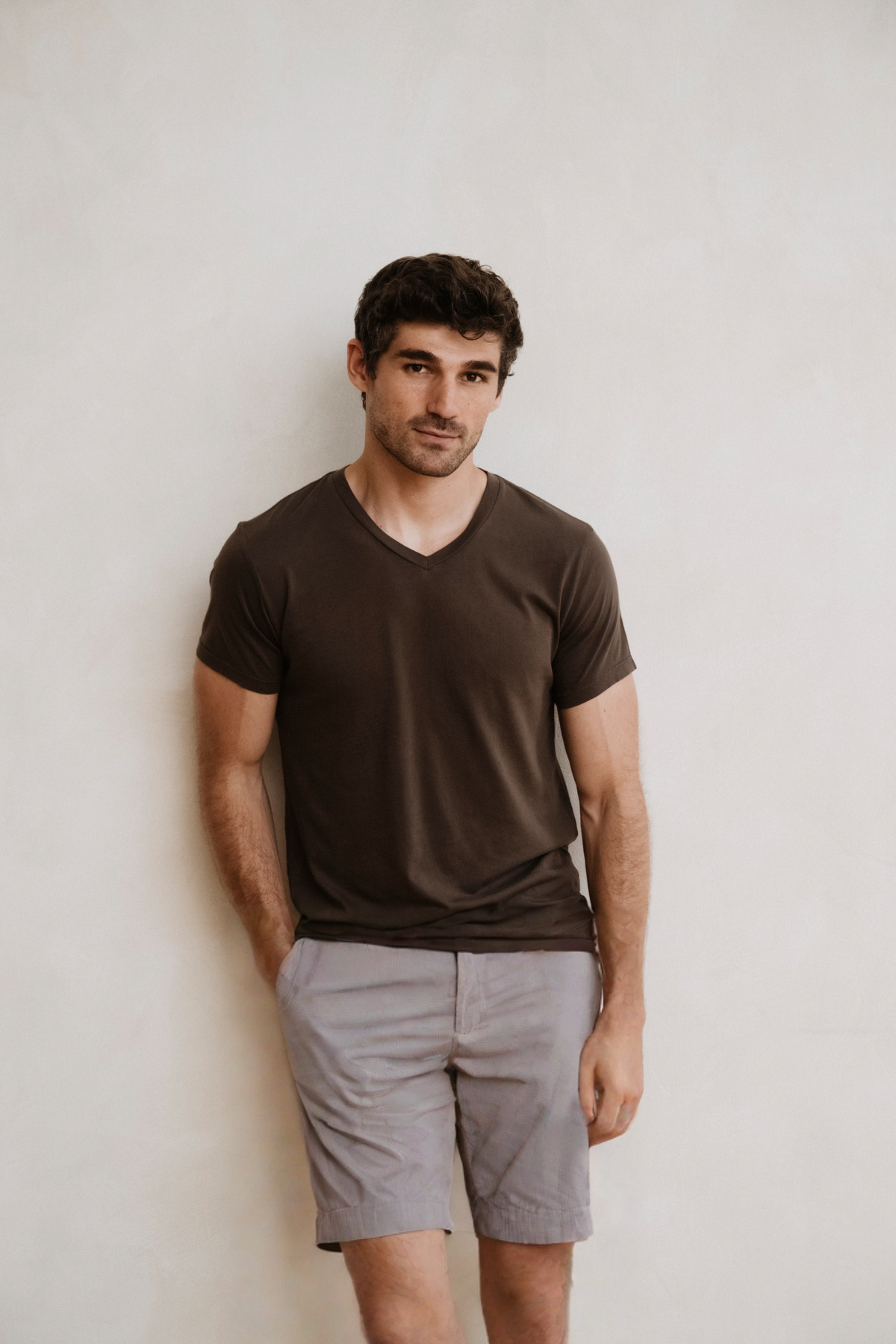 Light gray bermuda shorts with belt loops, zipper fly, and side pockets