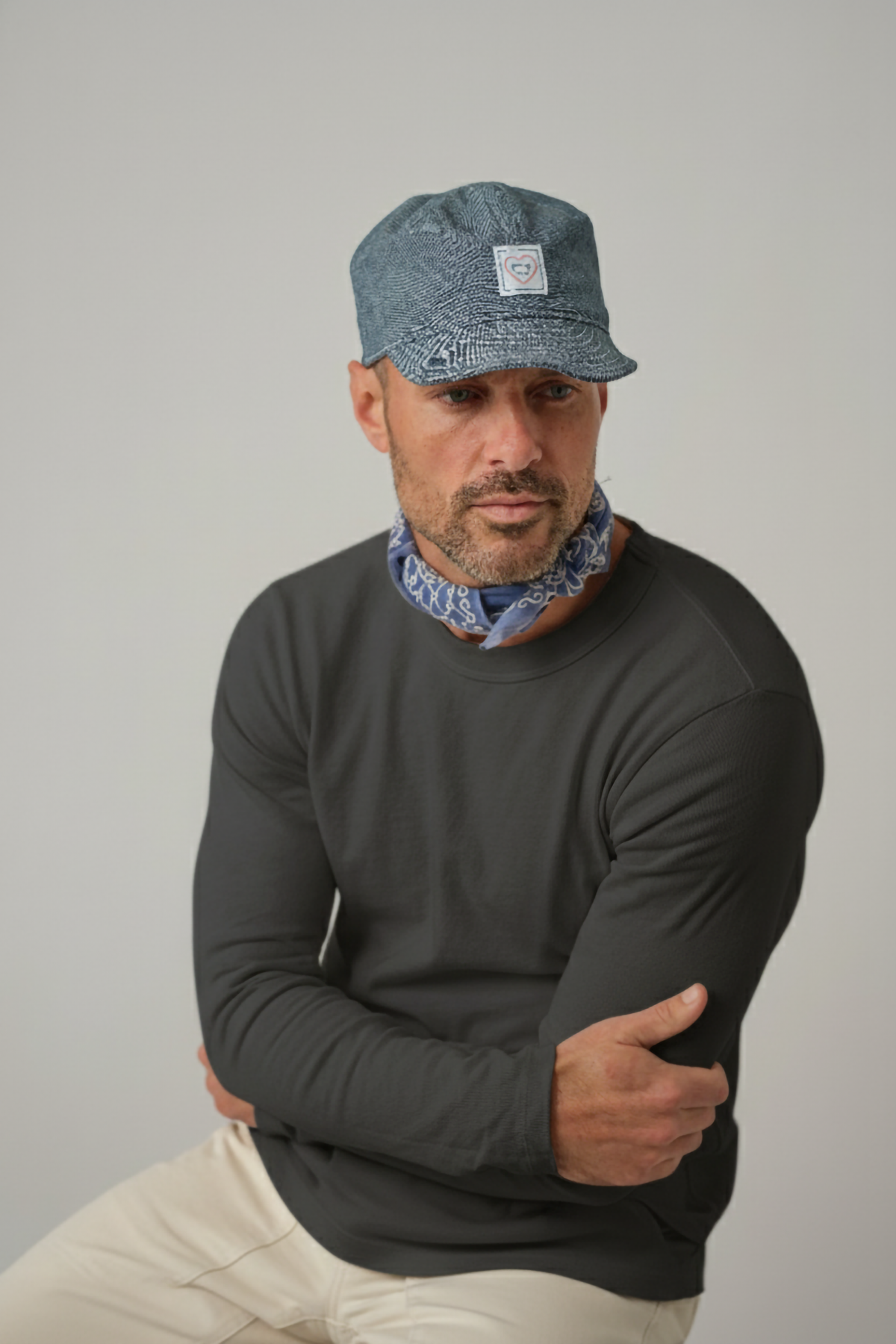 Dark gray long-sleeve layer tee worn by a man, crew neck and long sleeves visible