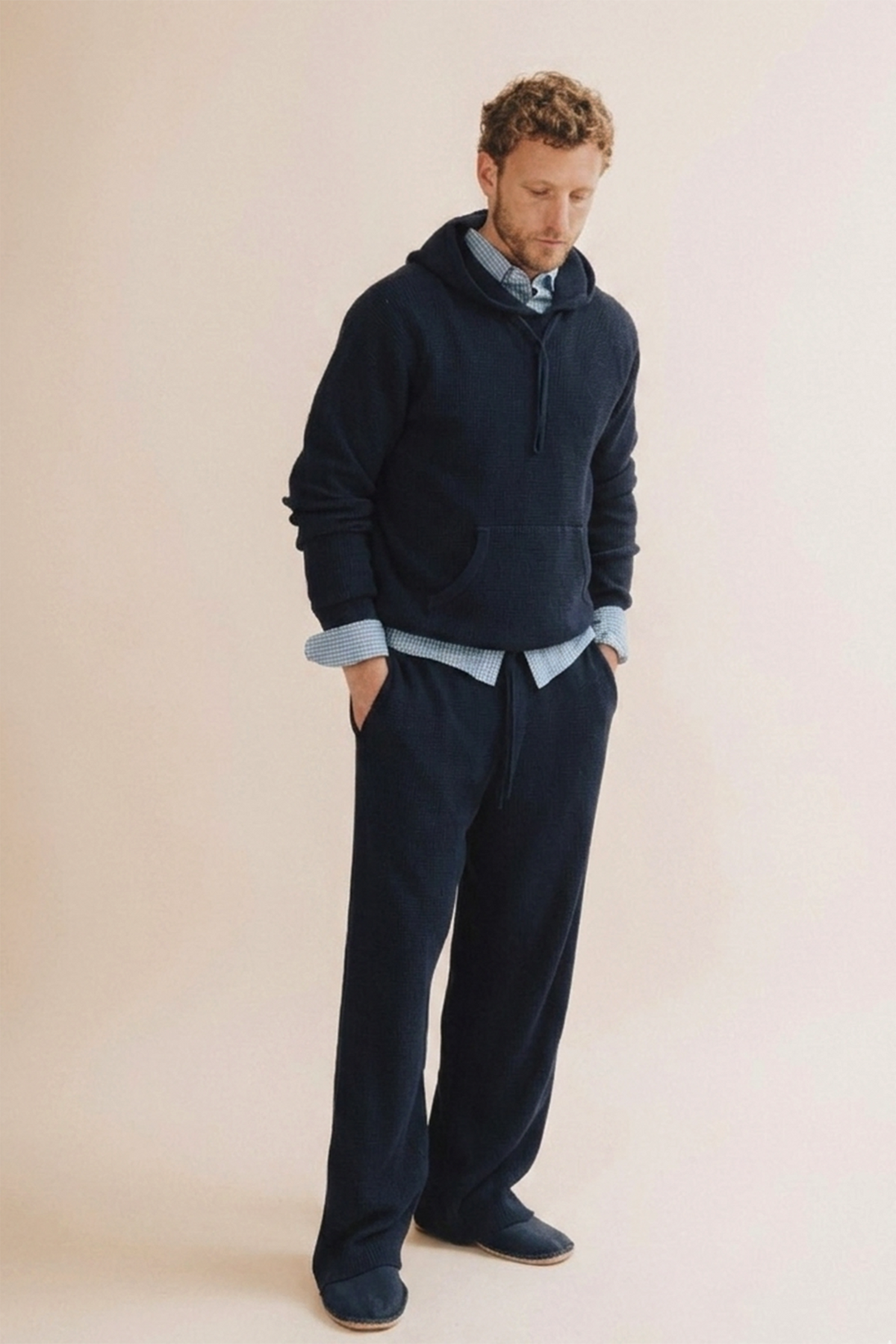 Navy waffle pants worn by model, showing drawstring waist and relaxed fit