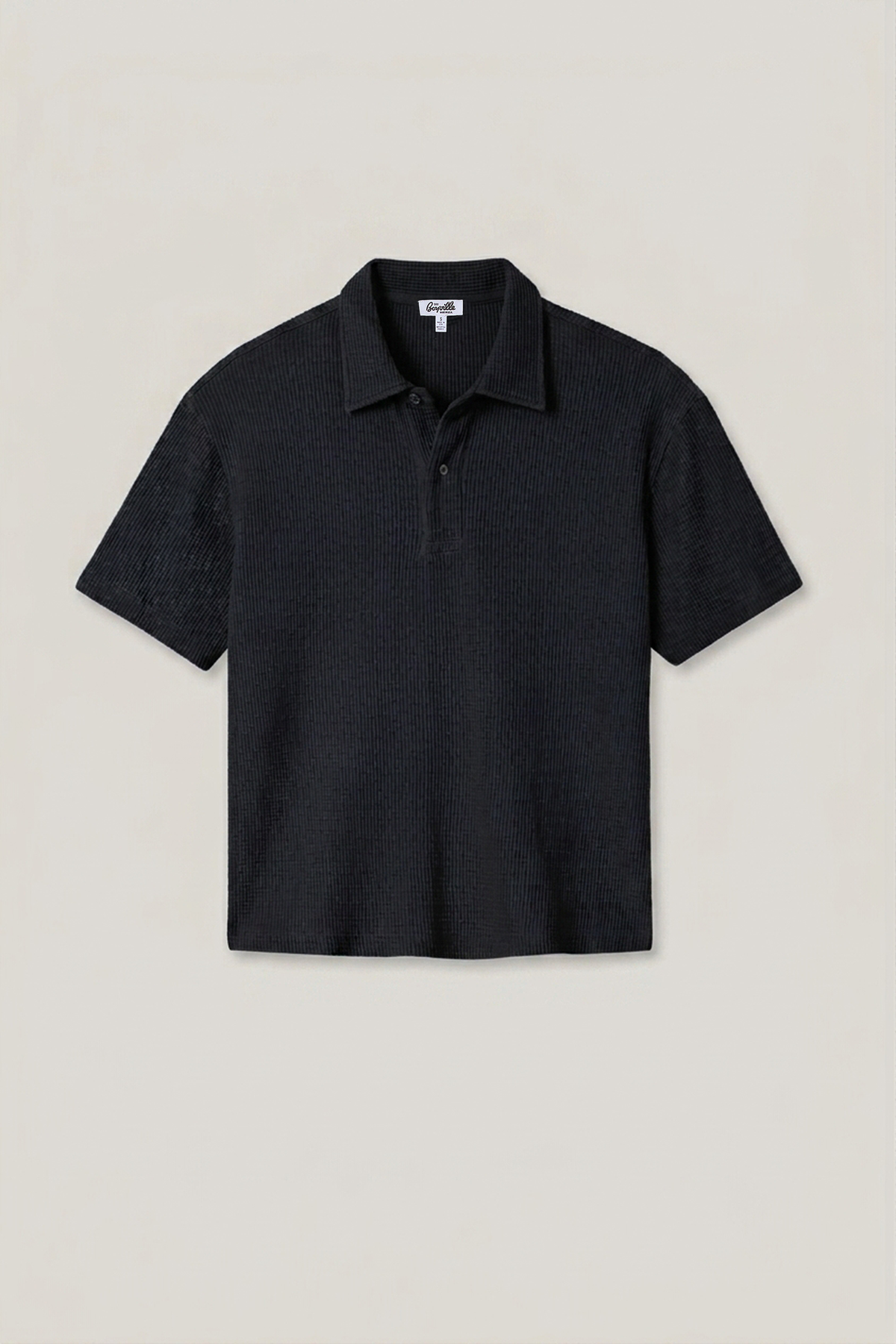 Black waffle knit polo shirt with short sleeves, spread collar, and 3-button placket