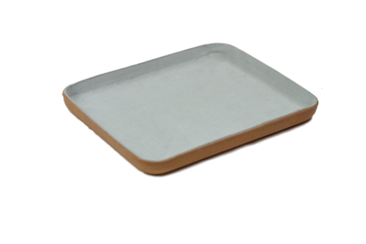 Light gray suede leather tray with rounded corners and smooth finish